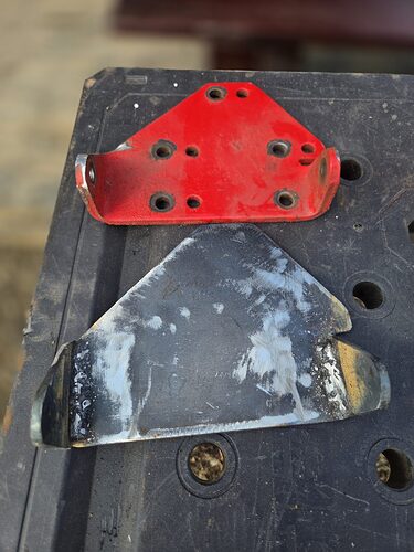 Alternator mounting brackets, one painted and one bare steel