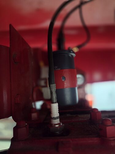 Close view of the 12 volt coil and spark plug