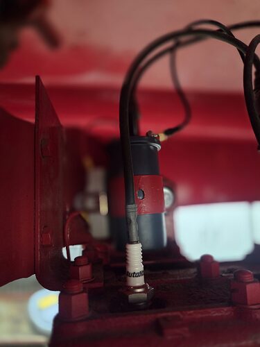 12 volt coil mounted on the engine with the plug wire